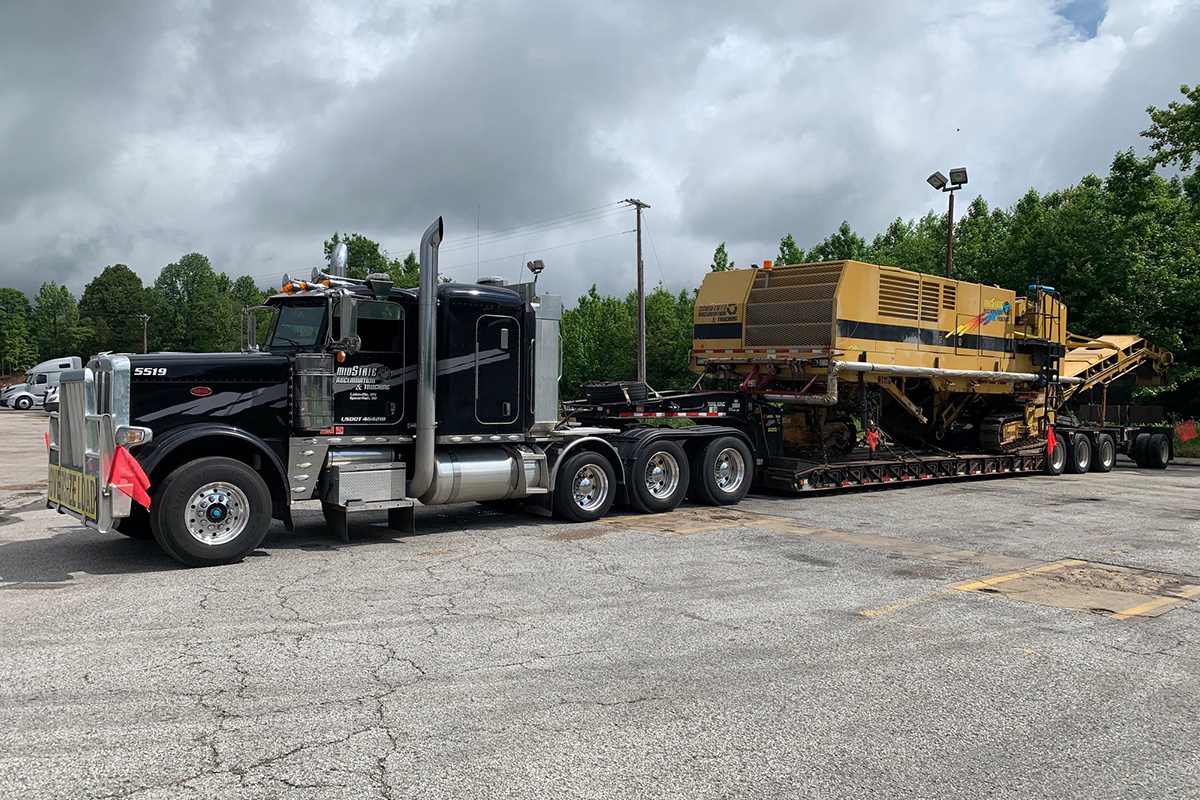 Midstate Companies truck hauling a large milling machine.